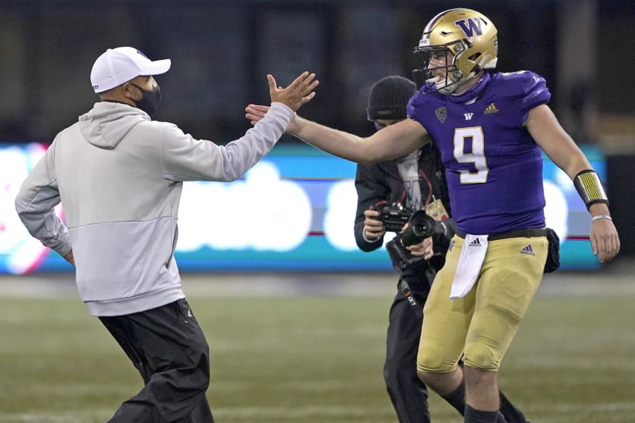Washington head coach Jimmy Lake, left, greets starting quarterback Dylan Morris (9) after Washington beat Oregon State 27-21 in an NCAA college football game, Saturday, Nov. 14, 2020, in Seattle. The game was Lake&#039;s first since he was named head coach. (AP Photo/Ted S.