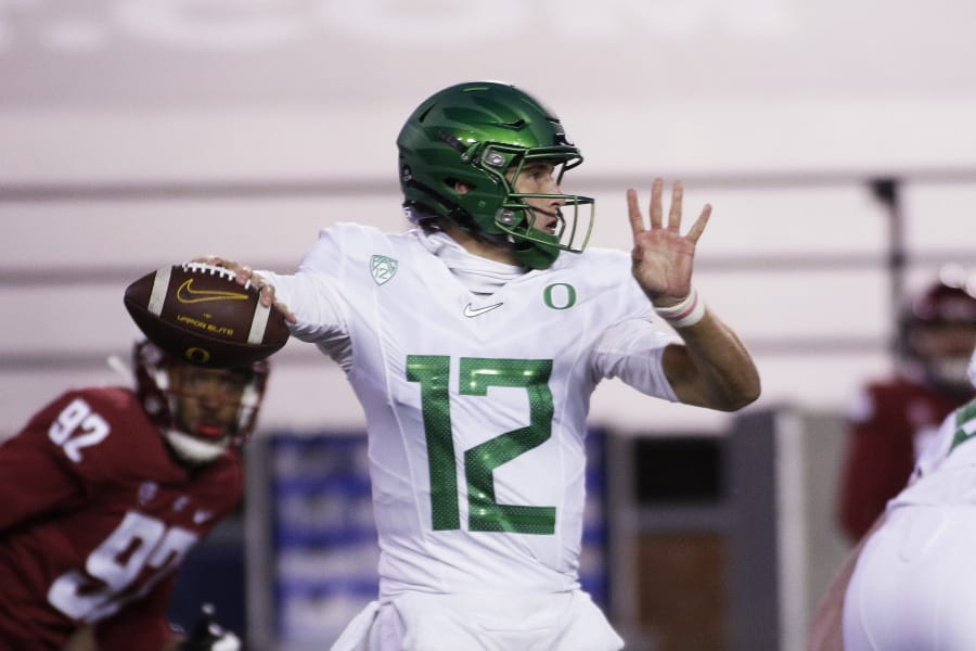 Oregon quarterback Tyler Shough (12) prepares to throw a pass during the first half of the team&#039;s NCAA college football game against Washington State in Pullman, Wash., Saturday, Nov. 14, 2020.