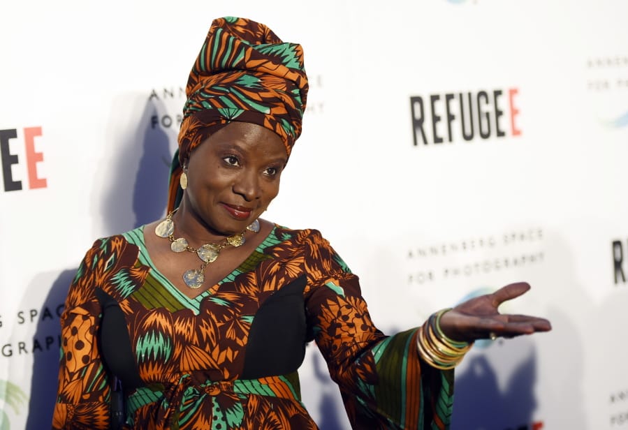 FILE - In this Thursday, April 21, 2016, file photo, singer and UNICEF Goodwill Ambassador Angelique Kidjo poses at the opening of the new photography exhibit &quot;REFUGEE&quot; at The Annenberg Space for Photography in Los Angeles. Kidjo uses her artistry and her activism to connect beyond language and skin color. Kidjo and other international musicians are performing social justice anthems for an online fundraising concert called Peace Through Music: A Global Event for Social Justice.