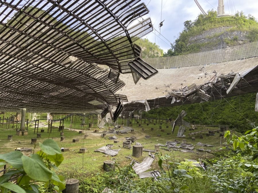The damage done to the Arecibo Observatory by a broken cable that supported a metal platform, creating a 100-foot gash to the radio telescope&#039;s reflector dish in Arecibo, Puerto Rico.