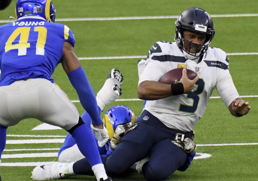 Seattle Seahawks quarterback Russell Wilson (3) scrambles against the Los Angeles Rams in the fourth quarter of an NFL football game in Inglewood, Calif., Sunday, Nov. 15, 2020.