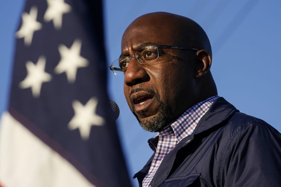 FILE - In this Nov. 15, 2020, file photo Raphael Warnock, a Democratic candidate for the U.S. Senate, speaks during a campaign rally in Marietta, Ga. Warnock and U.S. Sen. Kelly Loeffler are in a runoff election for the Senate seat.