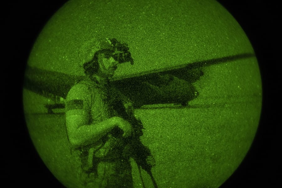 U.S. Army Spc. Dominic Deitrick, assigned to the 1-186th Infantry Battalion, Task Force Guardian, Combined Joint Task Force - Horn of Africa, seen through a night-vision device, provides security for a 75th Expeditionary Airlift Squadron (EAS) C-130J Super Hercules during unloading and loading operations Friday, June 12, 2020 at an unidentified location in Somalia. No country has been involved in Somalia&#039;s future as much as the United States but now the Trump administration is thinking of withdrawing the several hundred U.S. military troops from the nation at what some experts call the worst possible time. (Tech. Sgt.