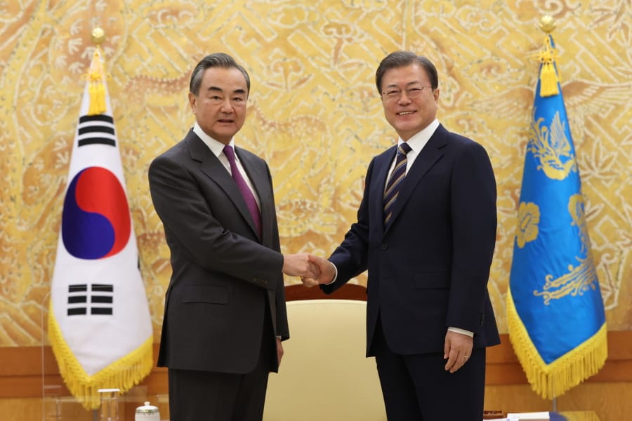 South Korean President Moon Jae-in, right, poses with Chinese Foreign Minister Wang Yi for a photo before a meeting at the presidential Blue House in Seoul, South Korea, Thursday, Nov. 26, 2020.