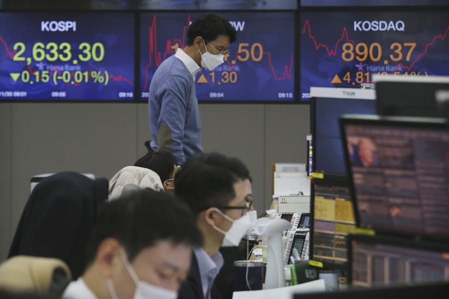 A currency trader watches monitors at the foreign exchange dealing room of the KEB Hana Bank headquarters in Seoul, South Korea, Monday, Nov. 30, 2020. Asian shares were mixed on Monday on renewed caution despite a record high finish on Wall Street last week driven by hopes for a COVID-19 vaccine and relief for the global economy.