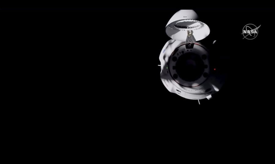 In this frame grab from NASA TV, the SpaceX Dragon capsule approaches the International Space Station, late Monday, Nov. 16, 2020.