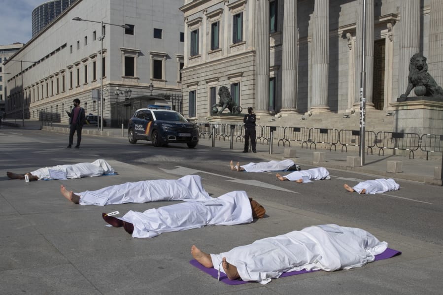 Activists from Extinction Rebellion lie down outside the Spanish parliament during a protest with symbolic corpses coinciding with All Saints&#039; Day, also known as Day of the Dead, Madrid, Spain, Sunday, Nov. 1, 2020. The protest is to call attention to the causes of death related to the climate crisis.