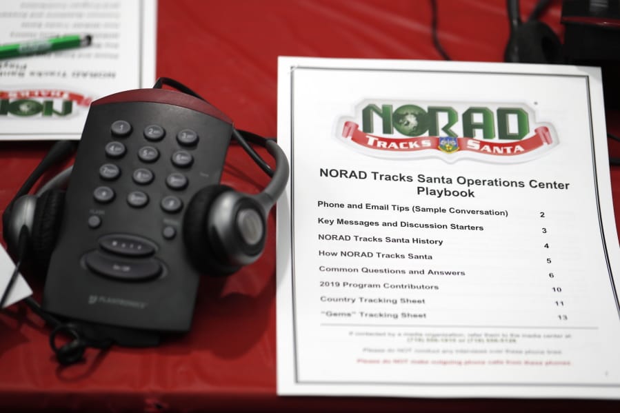 A playbook sits next to a telephone Dec. 23 in the NORAD Tracks Santa center at Peterson Air Force Base in Colorado Springs, Colo.