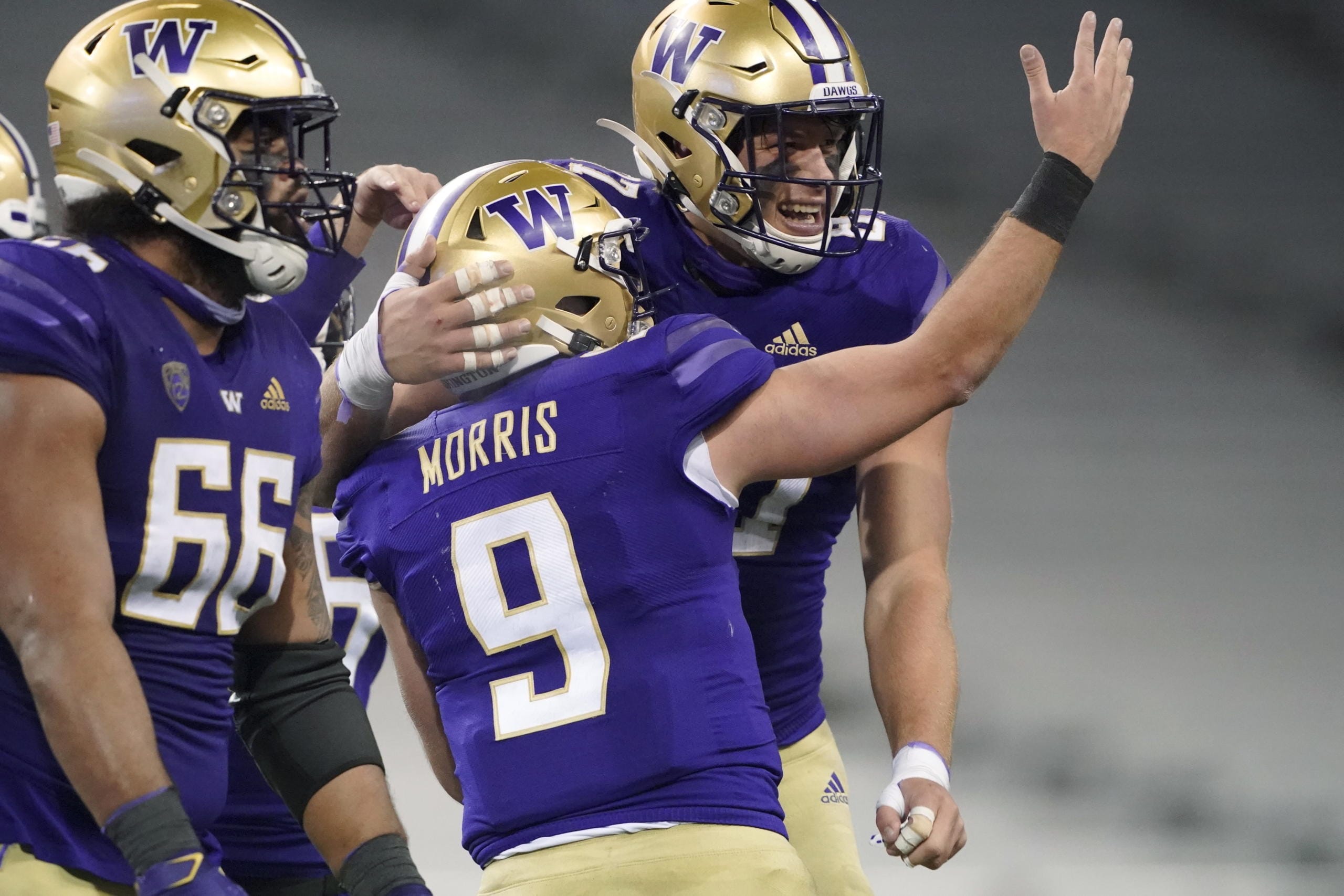 Washington quarterback Dylan Morris (9) celebrates with tight end Cade Otton, right, after Morris passed to Otton for a touchdown against Utah in the final minute of an NCAA college football game Saturday, Nov. 28, 2020, in Seattle. Washington won 24-21. (AP Photo/Ted S.