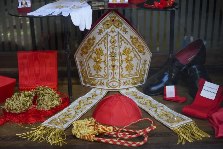 Cardinal clothing accessories are seen on display in the window of the Gammarelli clerical clothing shop, in Rome, Thursday, Nov. 26, 2020. The consistory to elevate new cardinals scheduled for Saturday, Nov. 28, in the time of coronavirus is like nothing the Holy See has ever seen. A handful of soon-to-be cardinals are in protective coronavirus quarantine, including African-American, Cardinal-designate Wilton Gregory, archbishop of Washington who explained that a U.S.-based ecclesiastical tailor took his measurements while he was still in Washington and sent them to Gammarelli, which then made them to order and sent them to Santa Marta hotel where he is undergoing the quarantine.