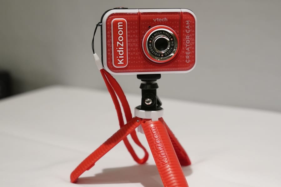 A KidiZoom Creator Cam by VTech is displayed at the Toy Fair, Thursday, Sept. 17, 2020, in New York. The digital camera comes with a green screen and animated backgrounds allowing kids to go to outer space, get chased by T-Rex, or make things disappear. The camera comes with a tabletop tripod, which can also be used as a selfie stick.