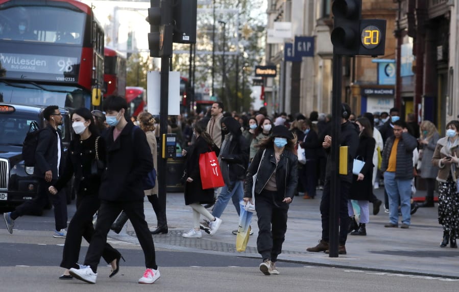 Shoppers walk along a very busy Oxford Street in London, Wednesday, Nov. 4, 2020, as Britain prepared to join large swathes of Europe in a coronavirus lockdown designed to save its health care system from being overwhelmed. Pubs, along with restaurants, hairdressers and shops selling non-essential items will have to close Thursday until at least Dec. 2.