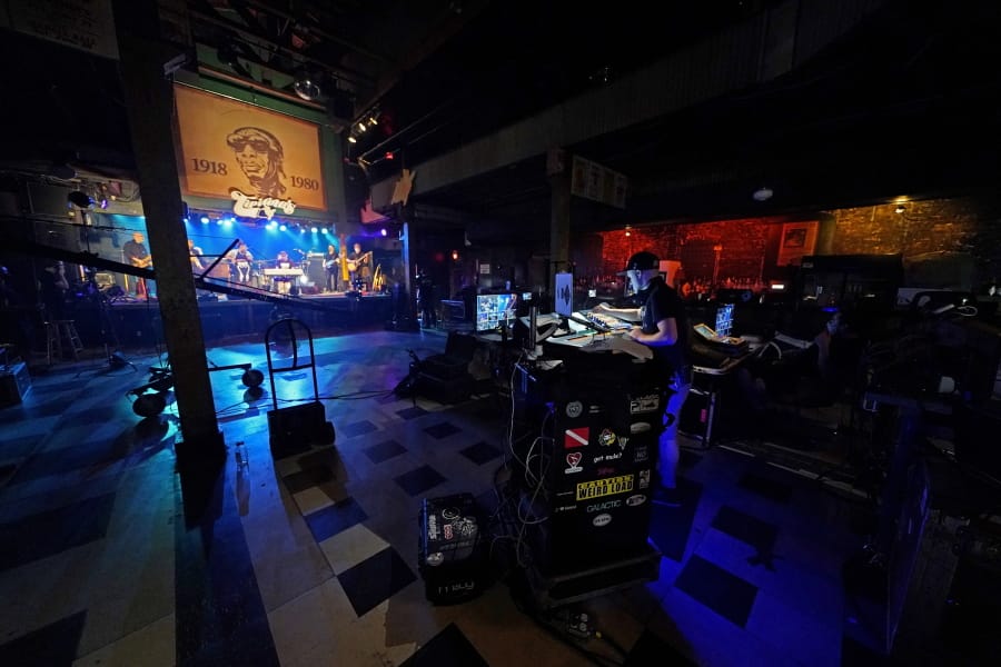 In this Oct. 26, 2020, photo, production engineers record the band Galactic for a video stream concert, inside an empty Tipitina&#039;s music club, which the band owns, in New Orleans. Music clubs all over the nation -- pop culture icons like the Troubadour in West Hollywood, the Bluebird Cafe in Nashville, The Bitter End in New York&#039;s Greenwich Village -- are shuttered due to the coronavirus. And owners fear for the future of their businesses and of a musical way of life.