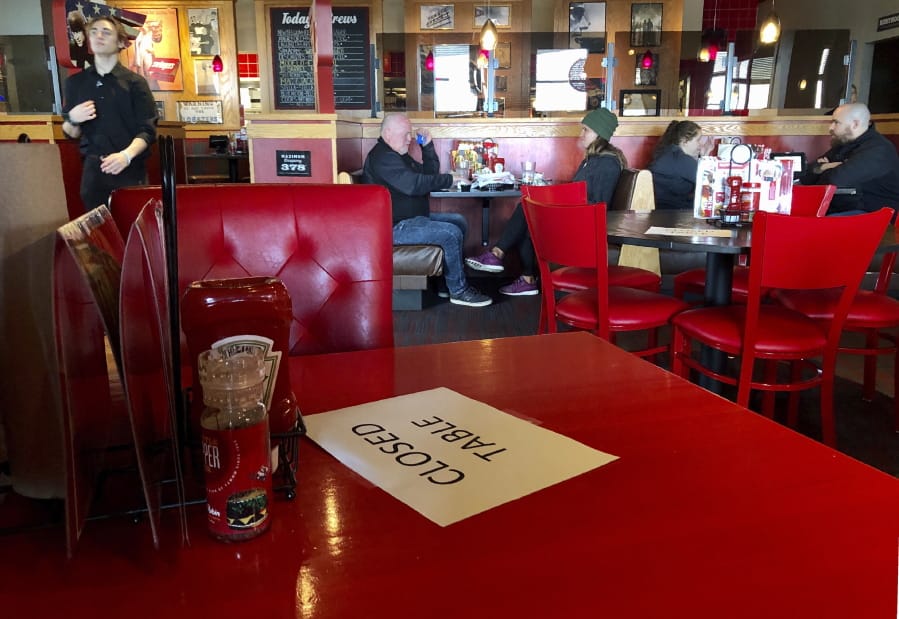 A Red Robin restaurant in Tigard, Ore., has closed some tables in order to maintain social distancing between diners per CDC guidelines in March. Much of Oregon is under a new round of restrictions.