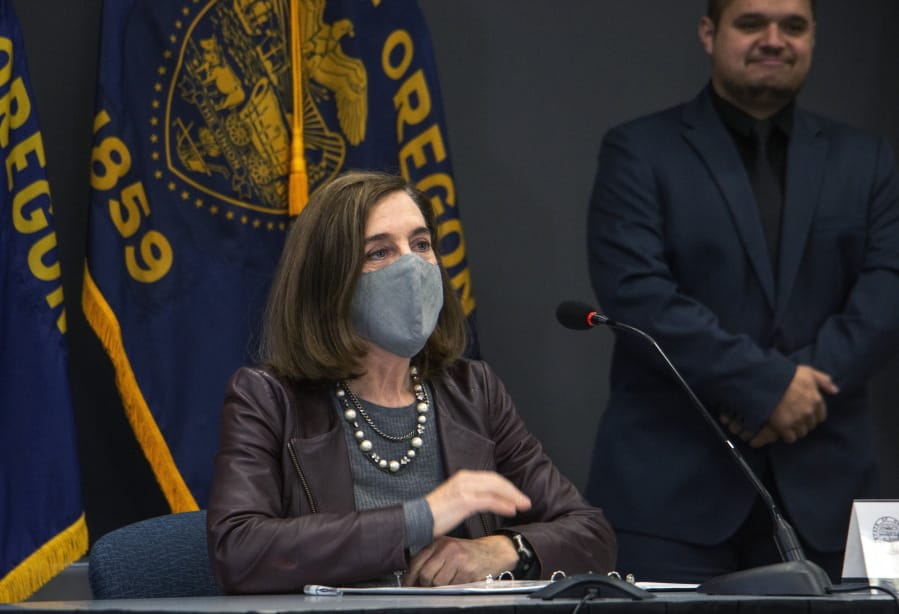 Oregon Gov. Kate Brown attends a news conference Tuesday, Nov. 10, 2020, in Portland, Ore. Brown and Oregon health officials warned Tuesday of the capacity challenges facing hospitals as COVID-19 case counts continue to spike in the state.