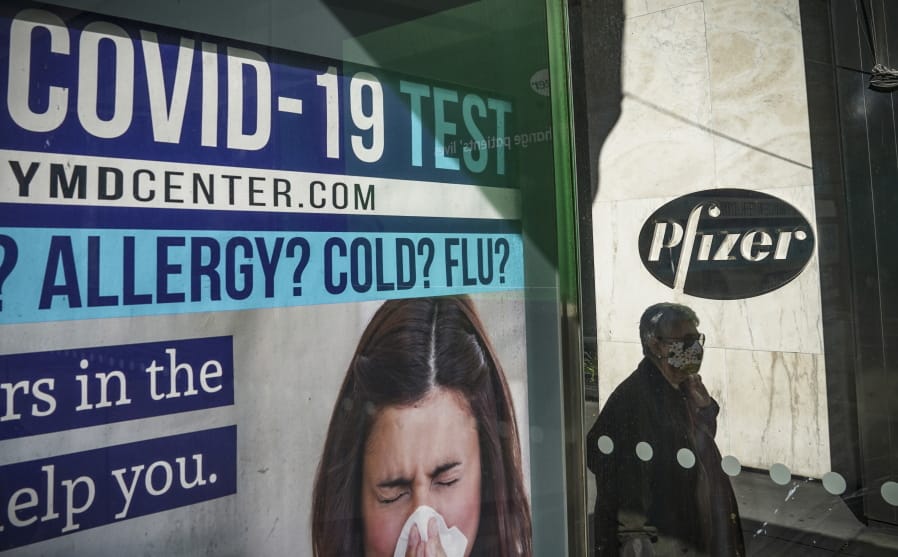 A bus stop ad for COVID-19 testing is shown outside Pfizer world headquarters in New York on Monday Nov. 9, 2020. Pfizer says an early peek at its vaccine data suggests the shots may be 90% effective at preventing COVID-19, but it doesn&#039;t mean a vaccine is imminent.