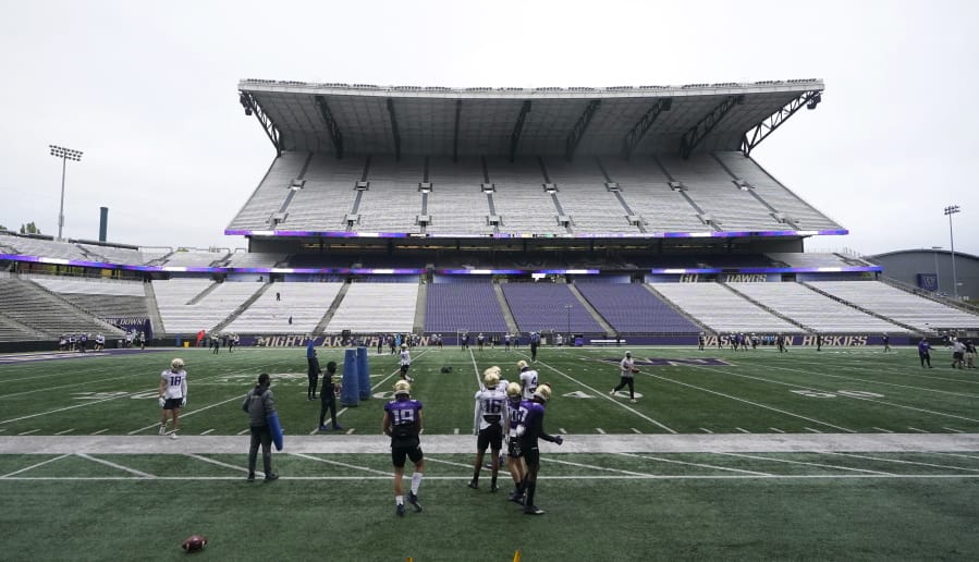 Washington players and coaches take part in NCAA college football practice, Friday, Oct. 16, 2020, at Husky Stadium in Seattle. (AP Photo/Ted S.