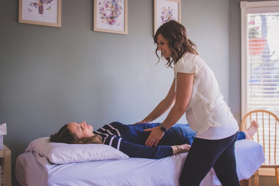 Christina Trautman, 35, assesses a patient by doing an abdominal exam. She assesses rib cage mobility and angle, tone of abdominals and checks breathing, among other things, to determine appropriate treatment for women experiencing pelvic floor issues. &quot;Literally everything you do during the day it requires some type of pelvic floor function. All of those things require stabilization and support,&quot; Trautman said.