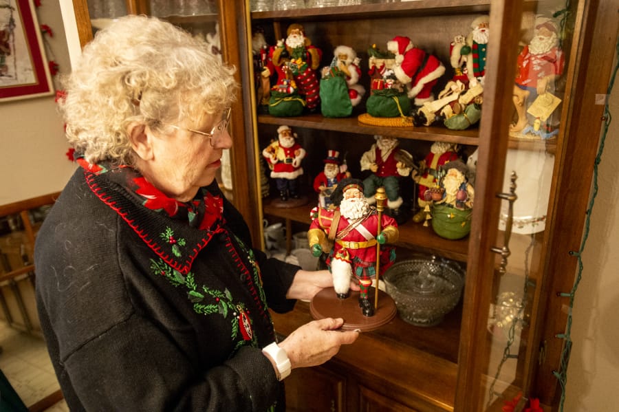Joanna Hamnes, 79, talks about her Norwegian-style Santa figurine. Her collection includes Santas in costumes from around the world.