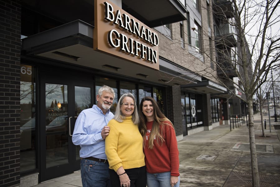 Rob Griffin, from left, and his wife, Deborah Barnard, pause for a portrait with their daughter, Megan Hughes, outside the new Barnard Griffin tasting room at The Waterfront Vancouver.