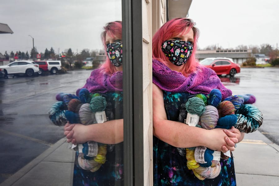 Eden Scheans holds bundles of yarn at Blizzard Yarn and Fiber in Vancouver. The store, at 6924 N.E. Fourth Plain Boulevard, is struggling to stay afloat during the pandemic.