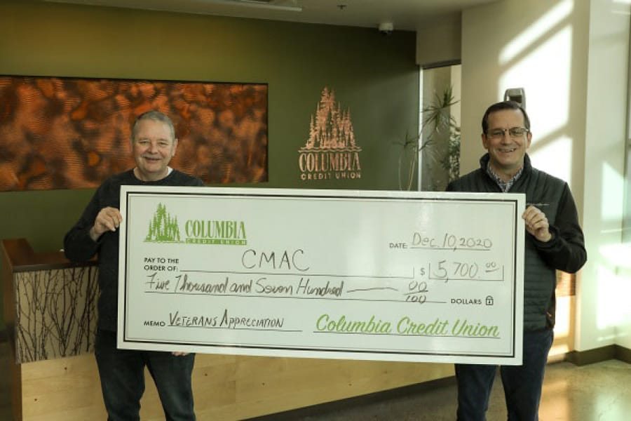 VANCOUVER: Columbia Credit Union President and CEO Steve Kenny, left, presents Community Military Appreciation Committee Board Member Bruce Evans with a check.