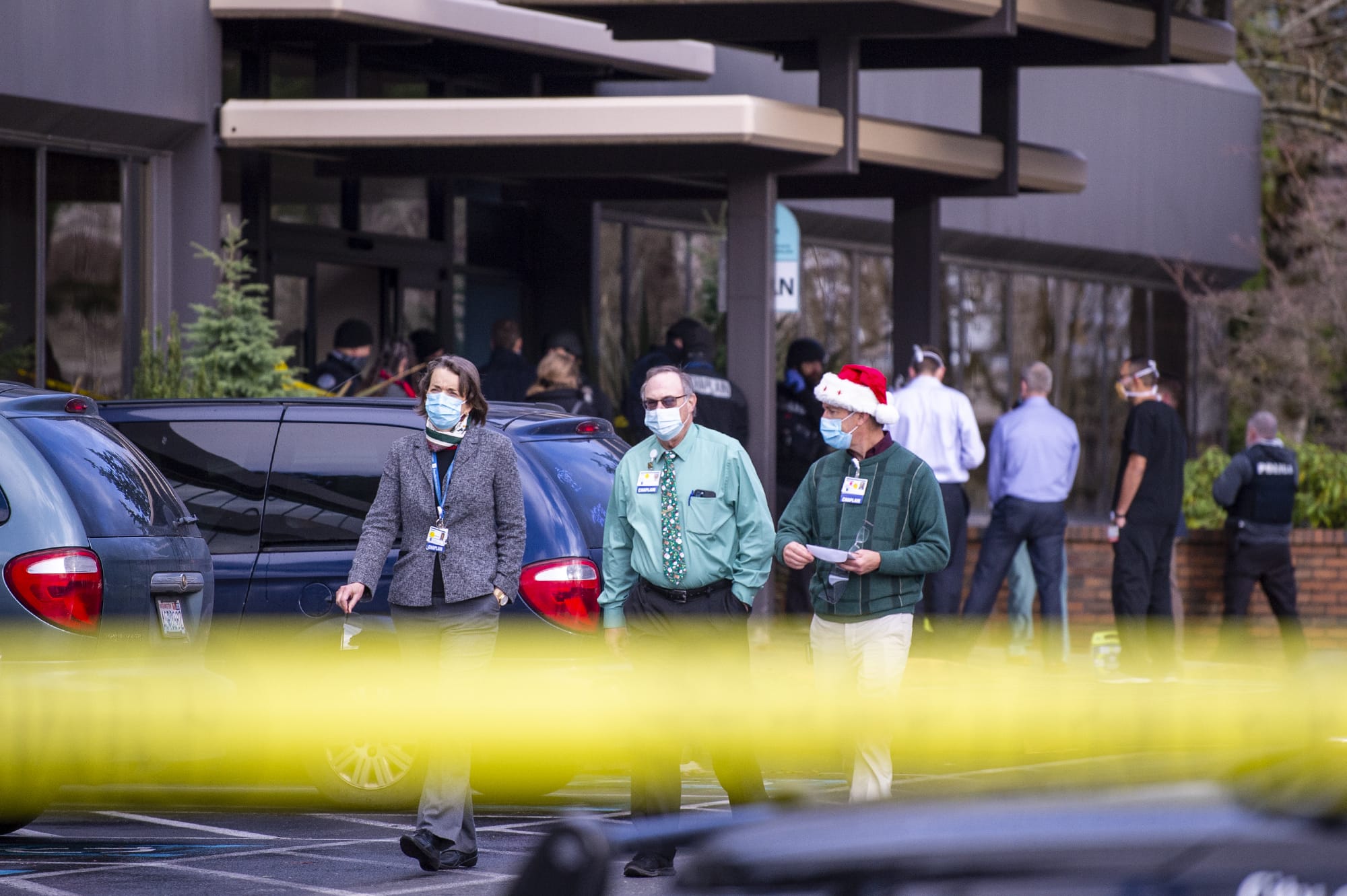 Three chaplains exit the building where a shooting reportedly occurred on Tuesday, December 22, at the 505 building at the PeaceHealth Southwest Medical Center.