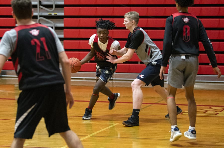 Fort Vancouver&#039;s Kahlil Singleton, center, at a practice back in January, found other teams to play with in other states during Washington&#039;s pandemic shut down of high school sports.