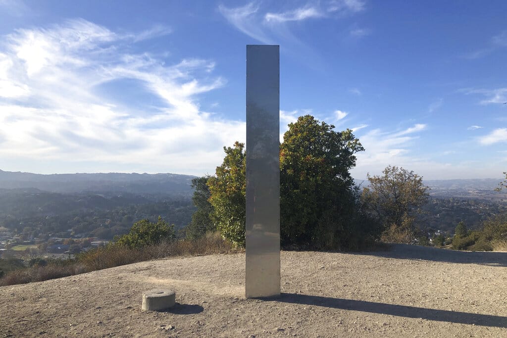 A monolith stands on a Stadium Park hillside in Atascadero, Calif., Tuesday, Dec. 2, 2020. Days after the discovery and swift disappearance of two shining metal monoliths half a world apart, another towering structure has popped up, this time at the pinnacle of a trail in Southern California. Its straight sides and height are similar to one discovered in the Utah desert and another found in Romania.