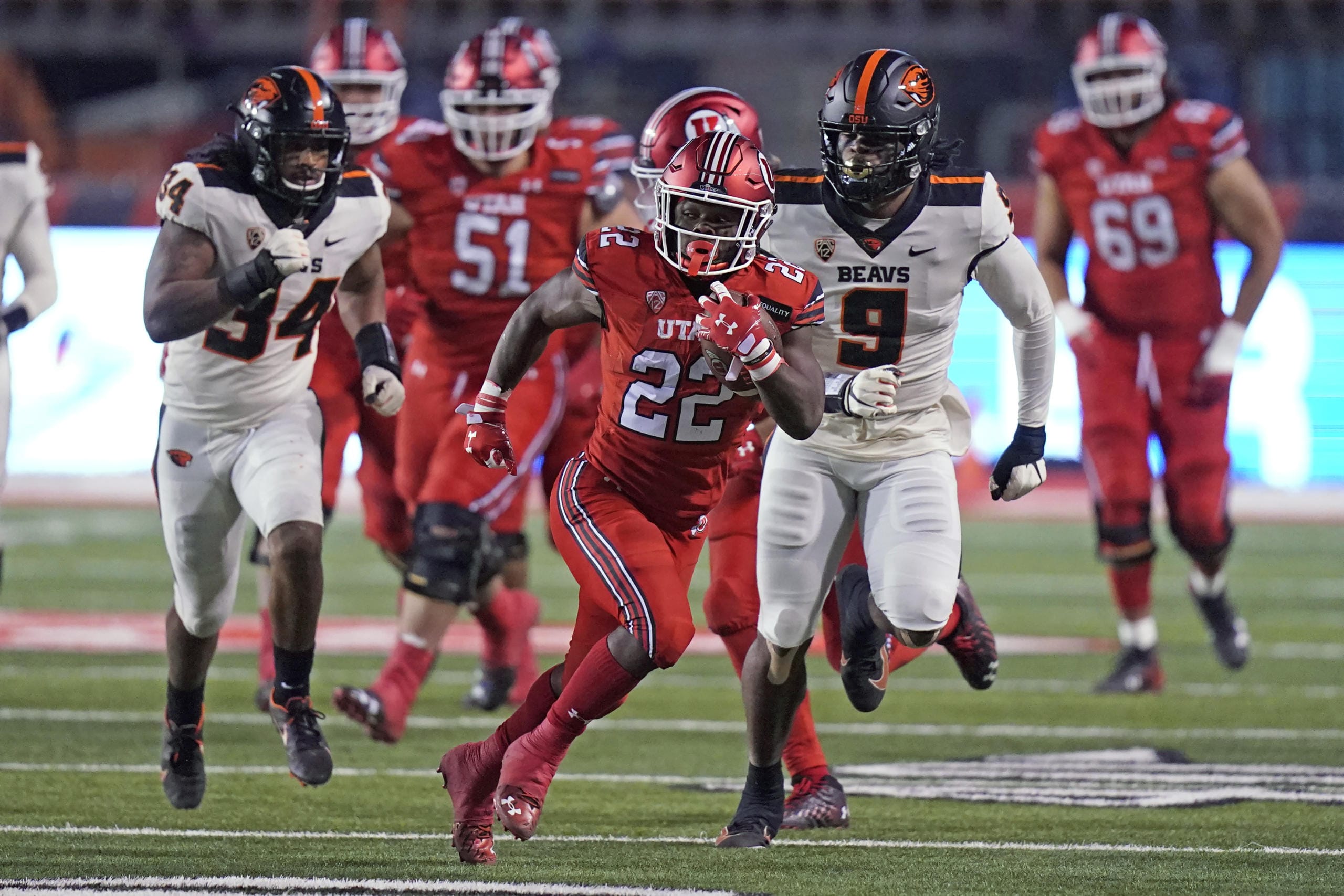 Utah running back Ty Jordan (22) carries the ball during the first half of the team's NCAA college football game against Oregon State on Saturday, Dec. 5, 2020, in Salt Lake City.