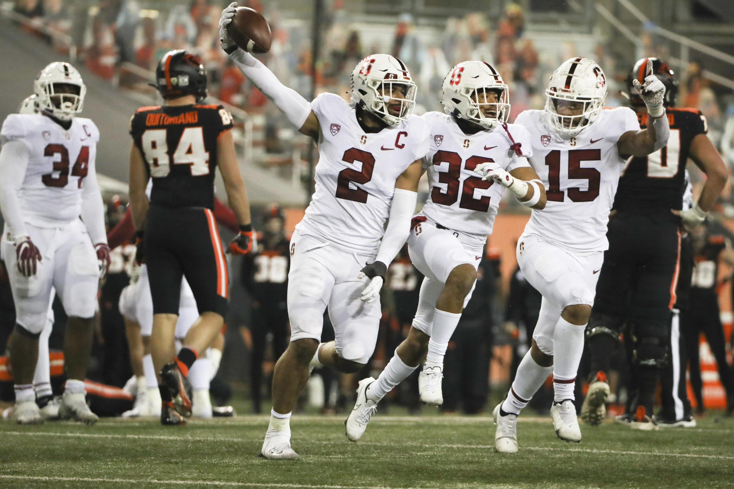 Stanford's Curtis Robinson (2), Jonathan McGill (32) and Stephen Herron (15) celebrate Robinson's recovery of an Oregon State fumble during the last minute of the second half in an NCAA college football game in Corvallis, Ore., Saturday, Dec. 12, 2020. Stanford won 27-24.