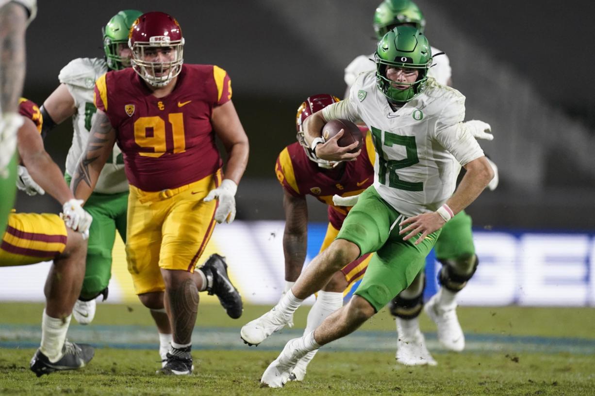 Oregon quarterback Tyler Shough (12) runs the ball during the second half of an NCAA college football game for the Pac-12 Conference championship against Southern California Friday, Dec 18, 2020, in Los Angeles.