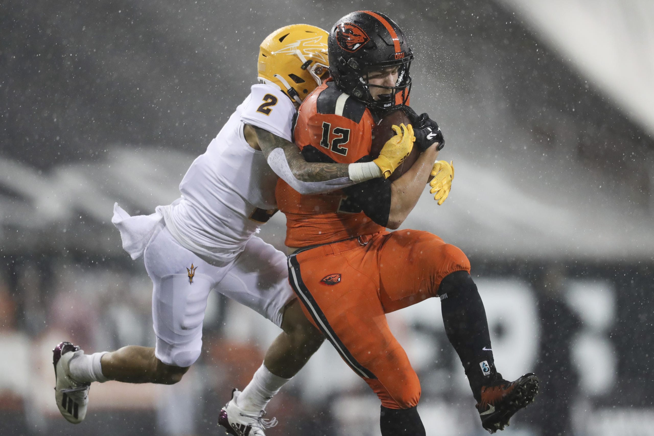 Oregon State inside linebacker Jack Colletto (12), a Camas High grad, is brought down by Arizona State defensive back DeAndre Pierce (2) during the first half of an NCAA college football game in Corvallis, Ore., Saturday, Dec. 19, 2020.
