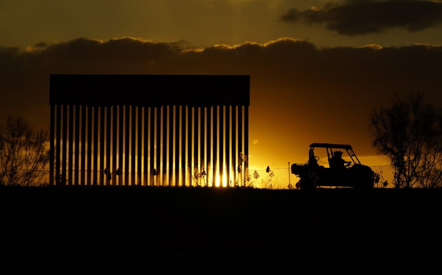 Authorities pass a border wall construction site, in Mission, Texas, Monday, Nov. 16, 2020. President-elect Joe Biden will face immediate pressure to fulfill his pledge to stop border wall construction. But he will confront a series of tough choices left behind by President Donald Trump, who&#039;s ramped up construction in his final weeks.