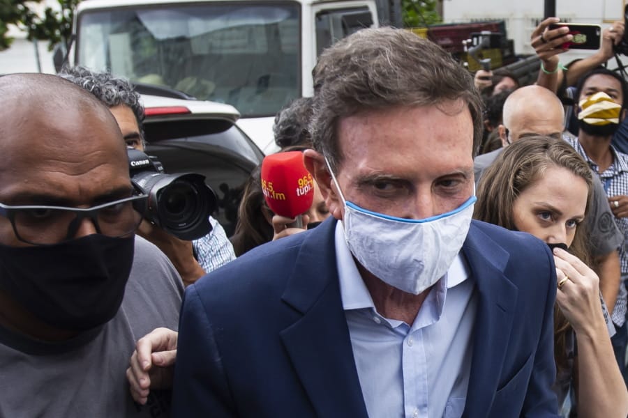 Rio de Janeiro Mayor Marcelo Crivella is escorted to a medical exam after his arrest, at the city police headquarters in Rio de Janeiro, Brazil, Tuesday, Dec. 22, 2020. Rio de Janeiro state police arrested the outgoing mayor on Tuesday in connection with an alleged kickbacks scheme.