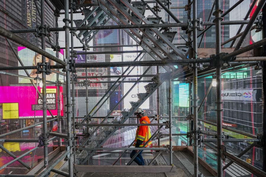 A construction worker walks down a staircase in the scaffolding of TSX Broadway under construction, Thursday, Oct. 29, 2020, in New York&#039;s, Times Square. The 46-story mixed-use property will house 75,000 square feet of retail space, a 4,000-square-foot performance venue including an outdoor stage, an outdoor food and beverage terrace and a luxury hotel. U.S. construction spending rose 0.3% in September, the fourth straight monthly gain after a coronavirus-caused spring swoon.