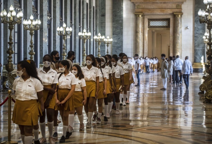 Students walk in a line as they arrive to pay their last respects to Havana&#039;s Historian Eusebio Leal during his funeral ceremony inside the &quot;Salon de Los Pasos Perdidos&quot; where his ashes are on display at the Capitol in Havana, Cuba, Thursday, Dec. 17, 2020. Leal died on July 31 of this year but funeral services were postponed due to the COVID-19 pandemic.