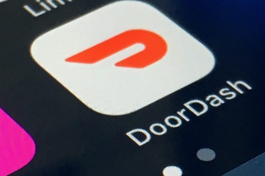 FILE - The DoorDash app is shown on a smartphone on Feb. 27, 2020, in New York. DoorDash is capping a year of explosive growth with an initial public offering, hoping to keep the momentum going even if demand for food delivery eases in a post-pandemic world.