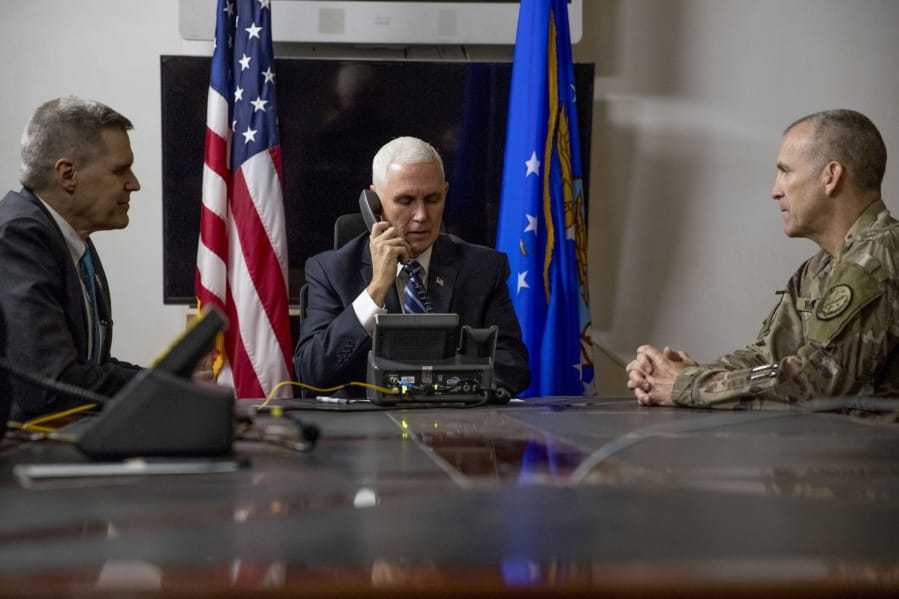FILE - In this Nov. 23, 2019, file photo Vice President Mike Pence, accompanied by U.S. Ambassador to Iraq Matthew Tueller, left, and Lt. Gen. Pat White, right, takes a phone call with Iraqi Prime Minister Adil Abdul-Mahdi at Al Asad Air Base, Iraq. White is the Fort Hood commander and he is facing the grim task of rebuilding trust and turning around an installation that has one of the highest rates of murder, sexual assault and harassment in the Army.
