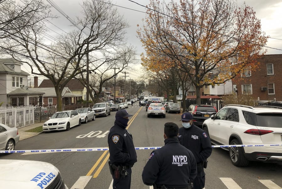 New York Police officers block off the street near the scene where a suspect was killed during a shootout with U.S. marshals in the Bronx that left two officers wounded, Friday, Dec. 4, 2020, in New York. The suspect, 35-year-old Andre Sterling, was wanted for shooting a Massachusetts state trooper in the hand on Nov. 20 during a traffic stop in Hyannis, Mass.