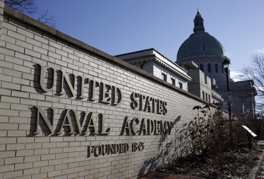 FILE - This Jan. 9, 2014 file photo shows a sign outside of an entrance to the U.S. Naval Academy campus in Annapolis, Md.  A federal judge in Baltimore has ruled that it is premature for her to decide whether to block the U.S. Naval Academy from expelling a midshipman for posting crude messages on social media. U.S. District Judge Ellen Hollander agreed Tuesday, Dec. 22, 2020, to dismiss Chase Standage&#039;s lawsuit and denied his request for a preliminary injunction allowing him to graduate from the academy.