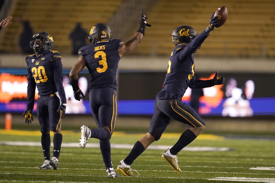 California linebacker Muelu Iosefa, right, celebrates with Josh Drayden (20) and Elijah Hicks (3) after recovering a fumble by Oregon wide receiver Johnny Johnson III during the second half of an NCAA college football game in Berkeley, Calif., Saturday, Dec. 5, 2020.