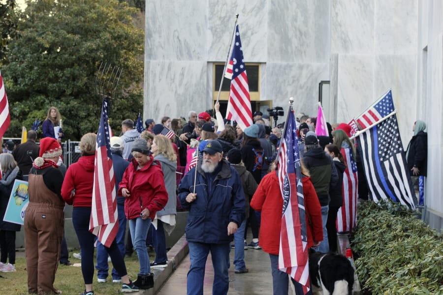 Pro-Trump and anti-mask demonstrators hold a rally outside the Oregon State Capitol on Monday, Dec. 21, 2020, as legislators meet for an emergency session.