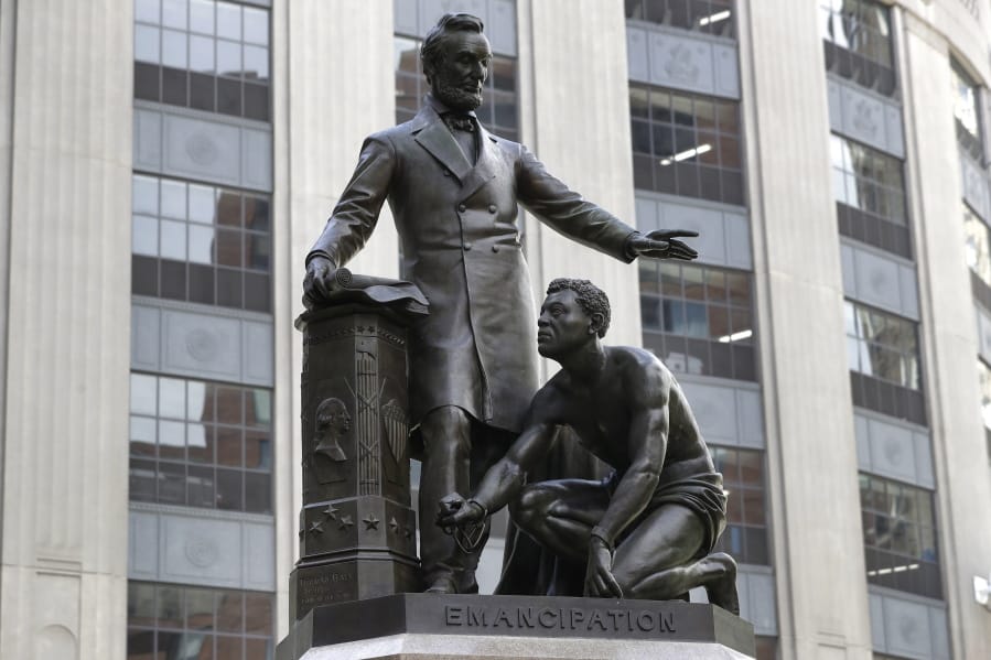 FILE - In this June 25, 2020, file photo, a statue that depicts a freed slave kneeling at President Abraham Lincoln&#039;s feet rests on a pedestal in Boston. On Tuesday, Dec. 29, the statue that drew objections amid a national reckoning with racial injustice was removed from its perch.
