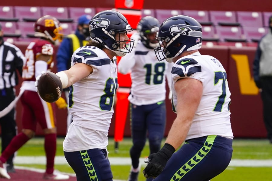 Seattle Seahawks tight end Jacob Hollister (86) celebrating his touchdown with teammate Seattle Seahawks center Ethan Pocic (77) during the first half of an NFL football game against the Washington Football Team, Sunday, Dec. 20, 2020, in Landover, Md.