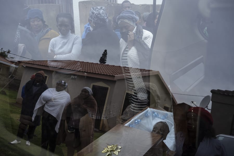 Mourners look at the body of 5-year-old Wandi Zitho at his funeral in Orange Farm, South Africa, on April 28, 2020. The boy was murdered in a suspected witchcraft ritual and his body was found in his neighbor&#039;s tavern.
