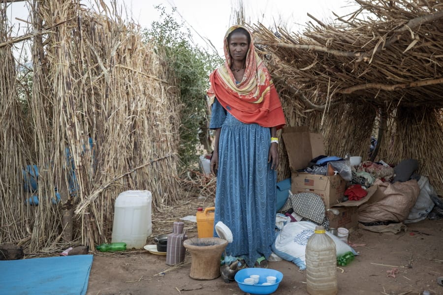 Ethiopian Tigrayan refugee 27-year-old Aksamaweet Garazgerer, who is living with HIV, stands in front of her temporary shelter at Umm Rakouba refugee camp in Qadarif, eastern Sudan, Monday, Dec. 7, 2020. Garazgerer has lived with HIV for the last 14 years and a trip to the clinic is a daily occurrence since she got to the camp searching for antiretroviral medication for HIV.