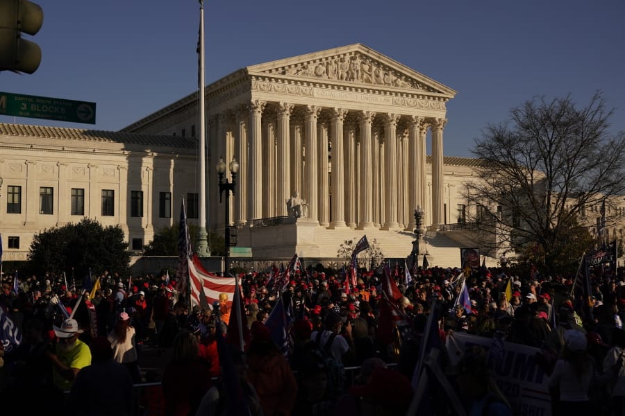 FILE - In this Nov. 14., 2020, file photo supporters of President Donald Trump attend pro-Trump marches outside the Supreme Court Building in Washington. The Supreme Court is hearing arguments over whether the Trump administration can exclude people in the country illegally from the count used for divvying up congressional seats.