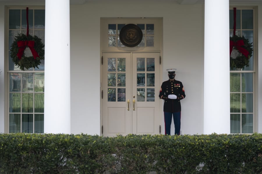 A Marine stands outside the entrance to the West Wing of the White House, signifying the President is in the Oval Office, Monday, Dec. 21, 2020, in Washington.