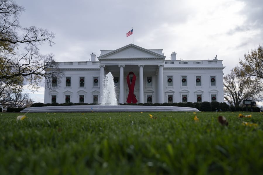 A ribbon hangs on the White House for World AIDS Day 2020, Tuesday, Dec. 1, 2020, in Washington.